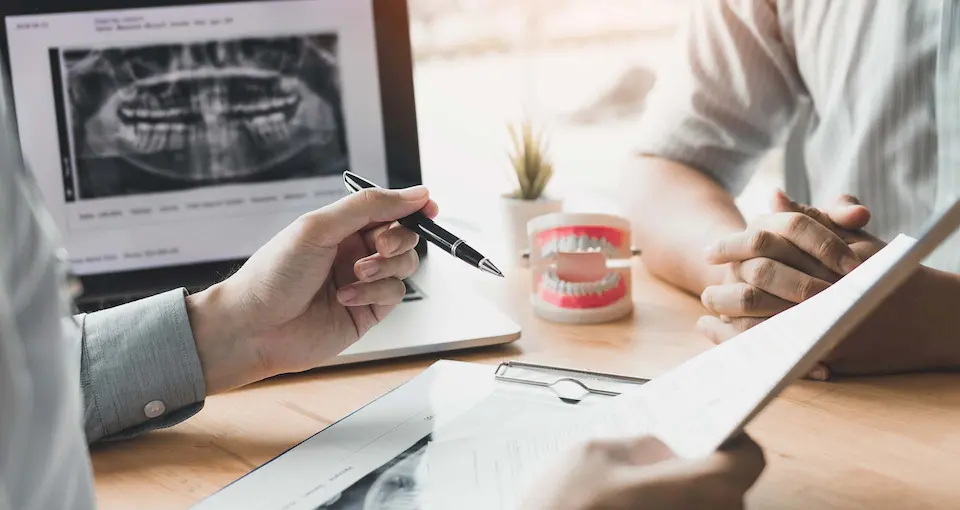 Two people showing hands only discussing dental costs